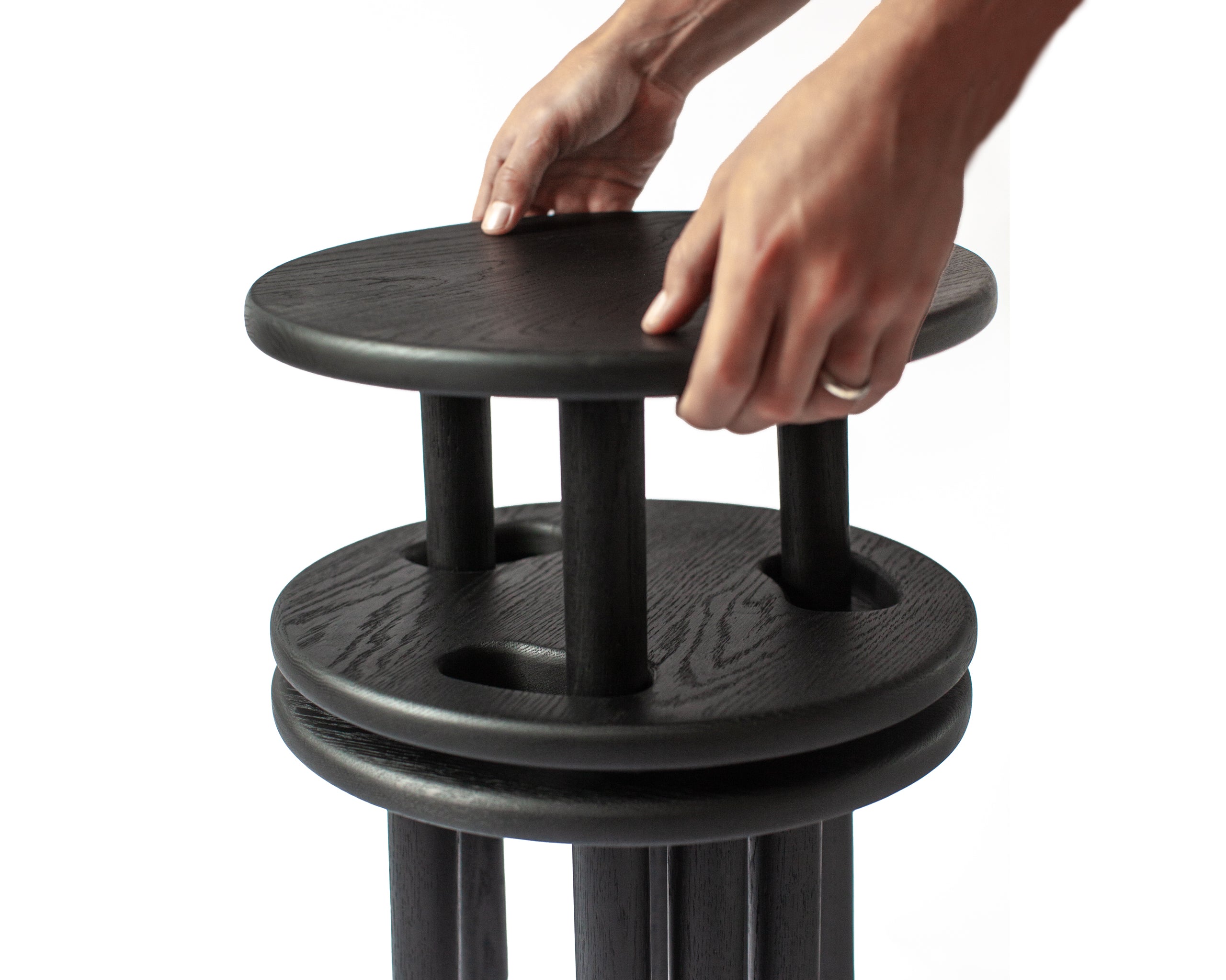 stackable stools in black stain on white back ground