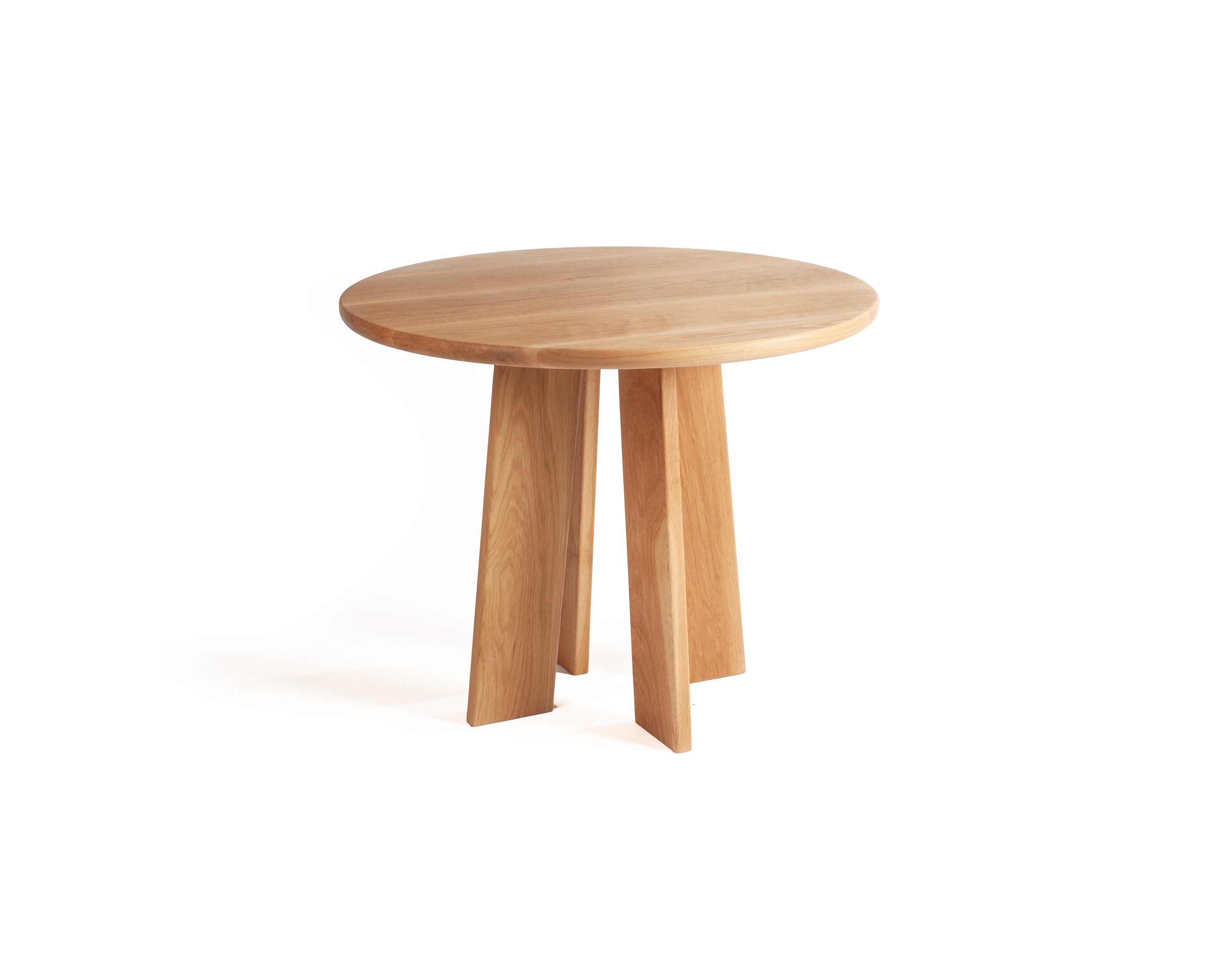 Minimalist round dining table in solid white oak with natural grain detail