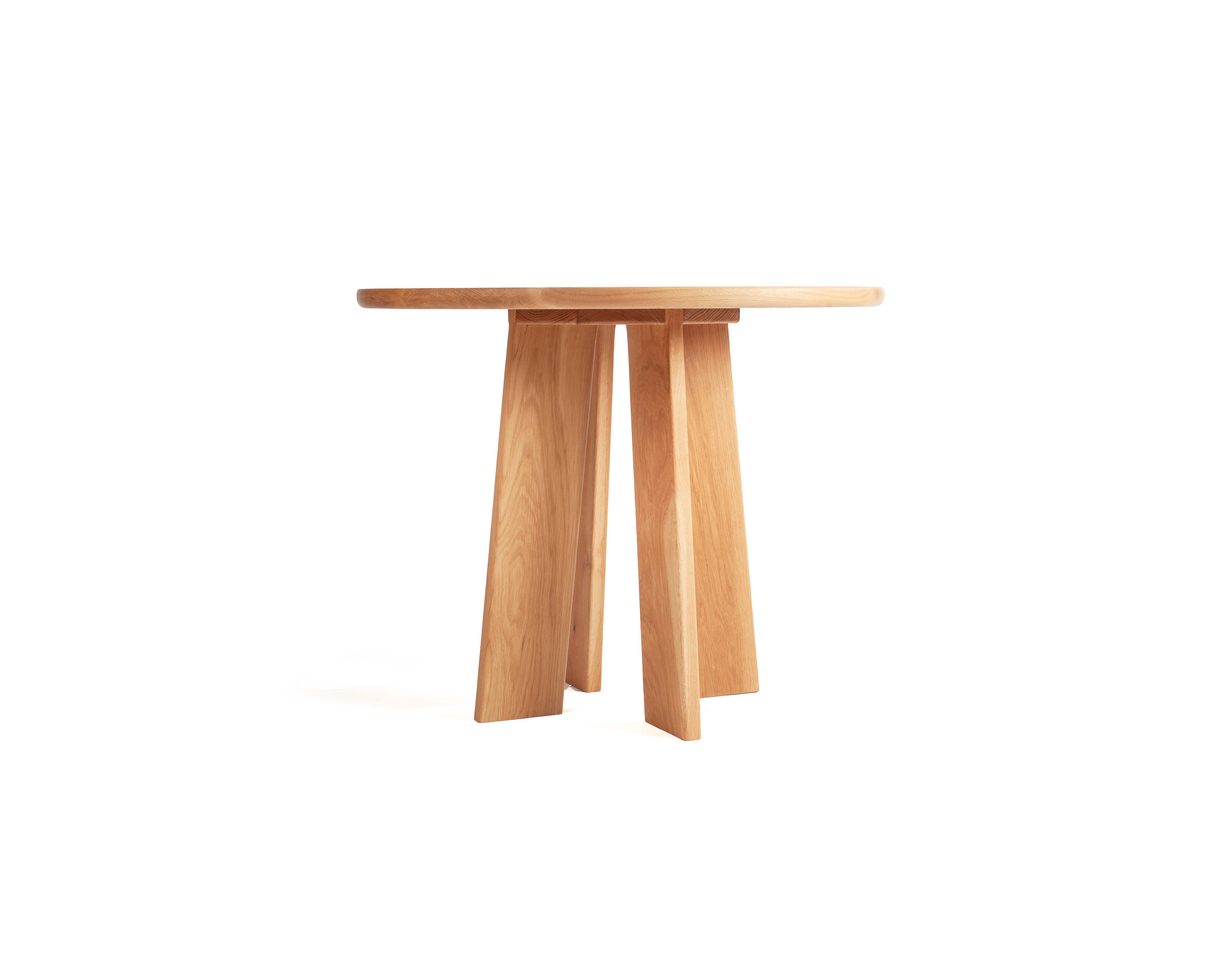 Minimalist round dining table in solid white oak with natural grain detail