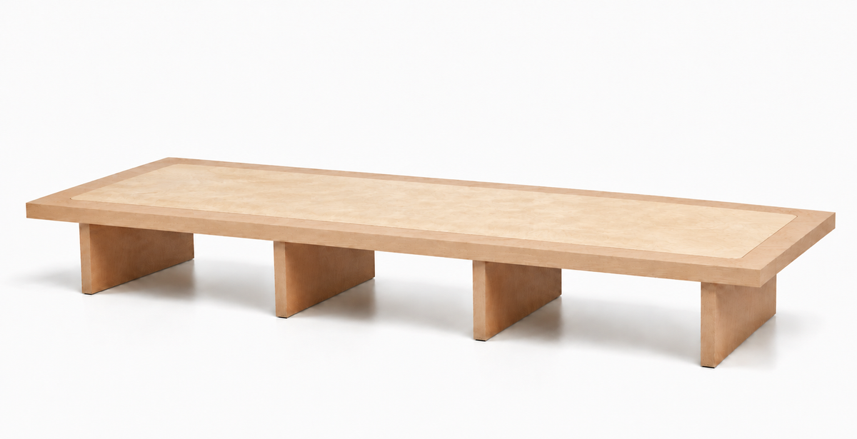 A modern low-profile wooden bench with a light natural wood finish, featuring a thick rectangular seat and three block-style legs, shown on a clean white background.