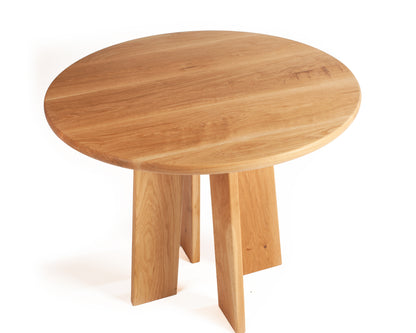 Minimalist round dining table in solid white oak with natural grain detail