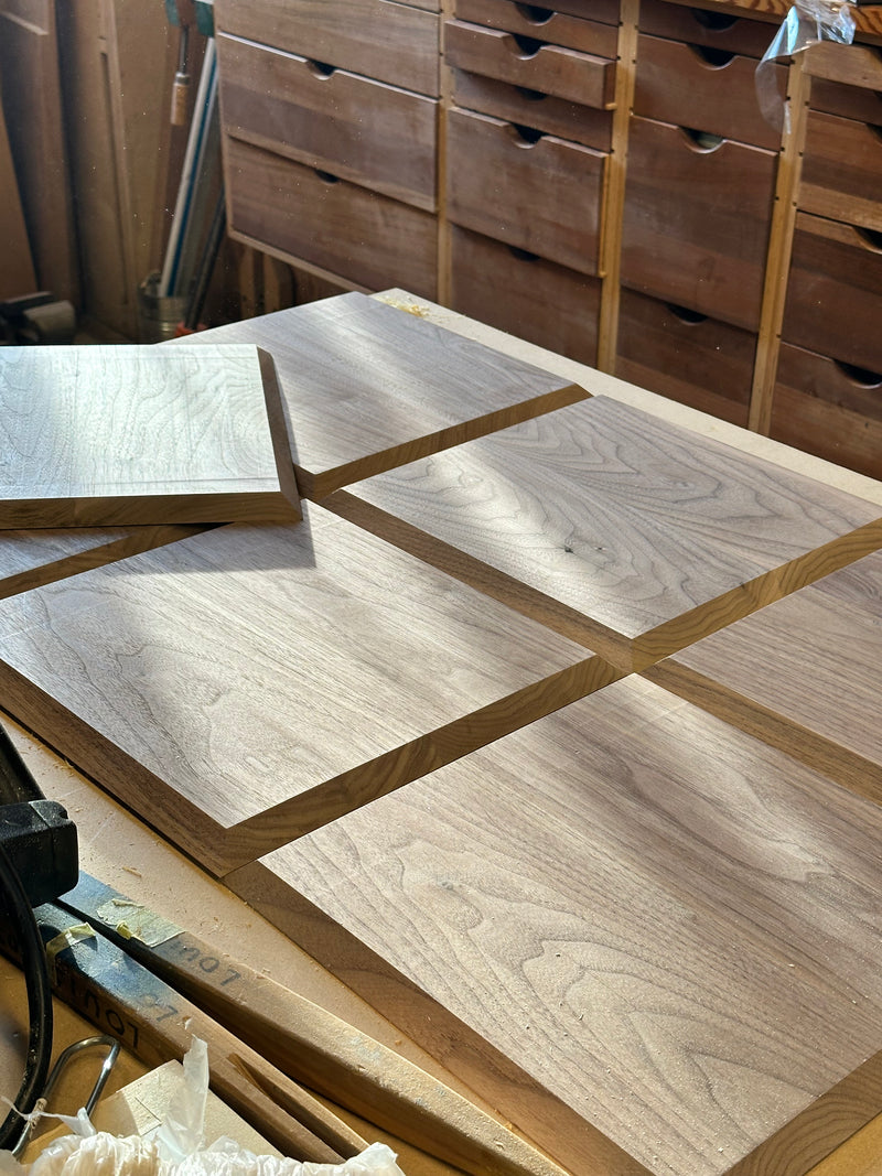 Wooden panels with a checkered pattern on a workbench