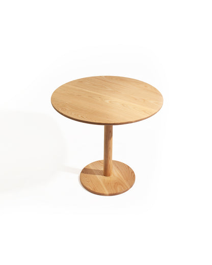 Minimalist solid ash tulip table with round top and sculpted pedestal base